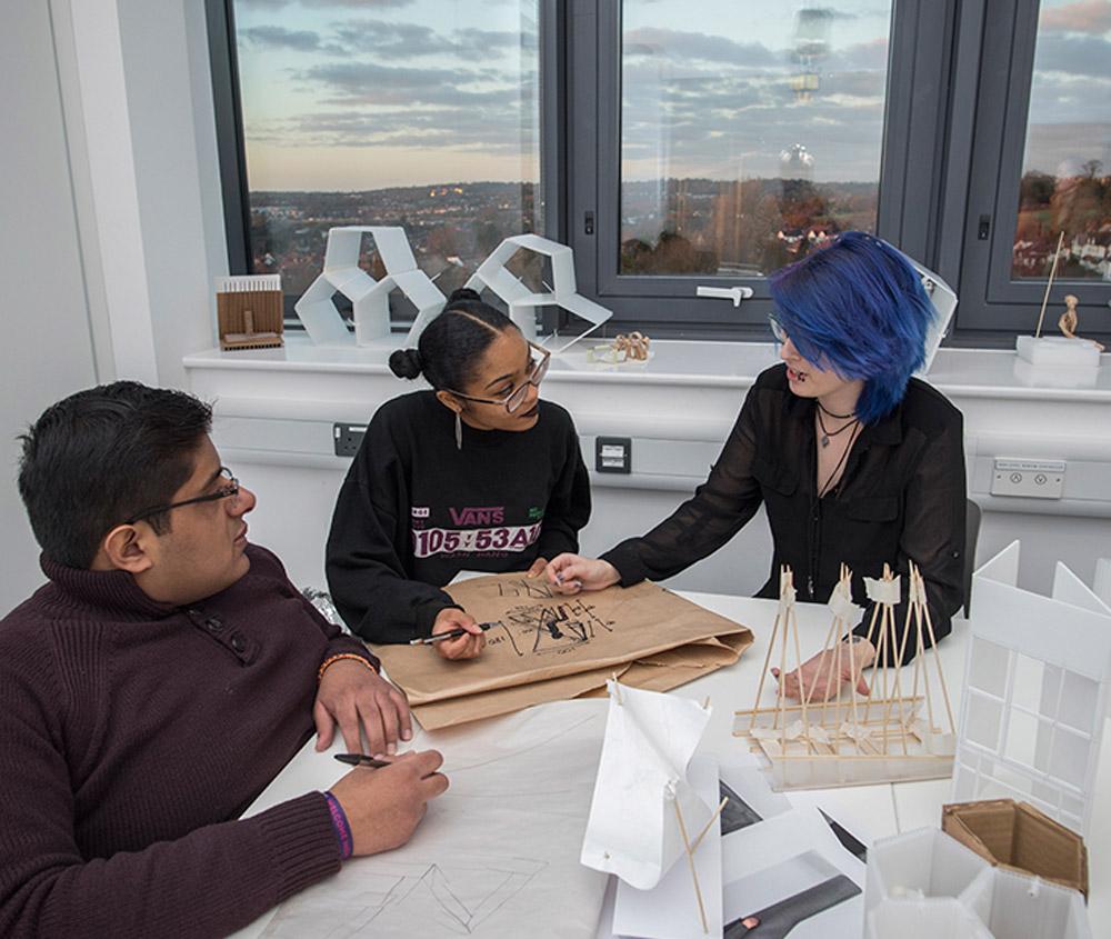 Young students looking at interior architecture design sketches