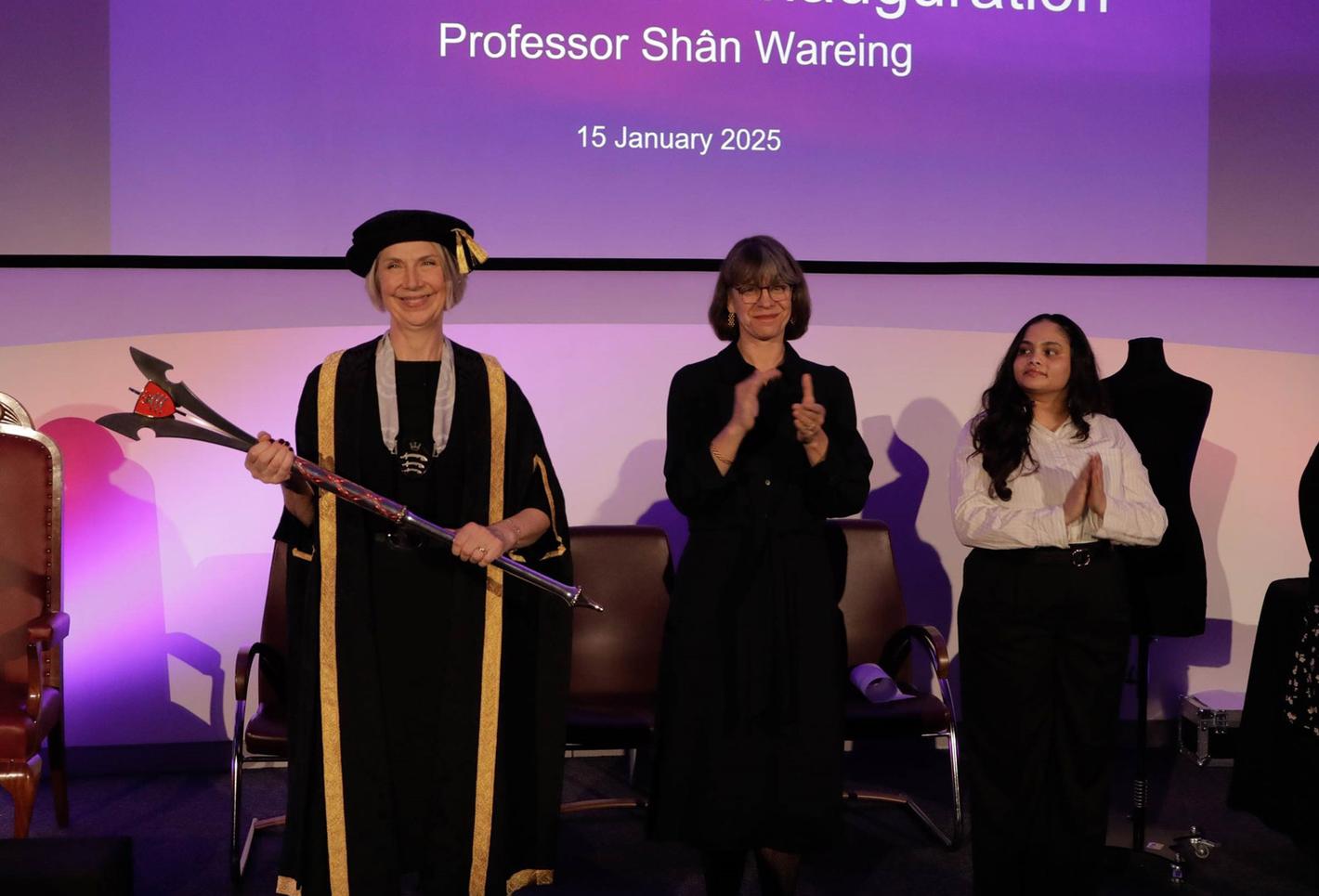 Middlesex University VC celebrating her inauguration alongside a group of people