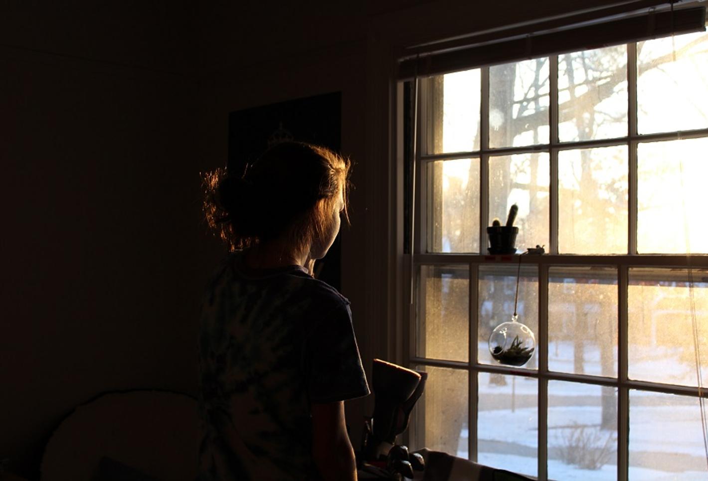A girl looking through a window