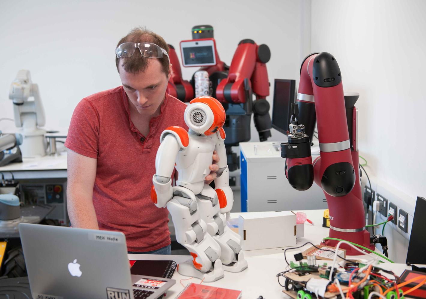 A student working with robots in the mechatronics lab
