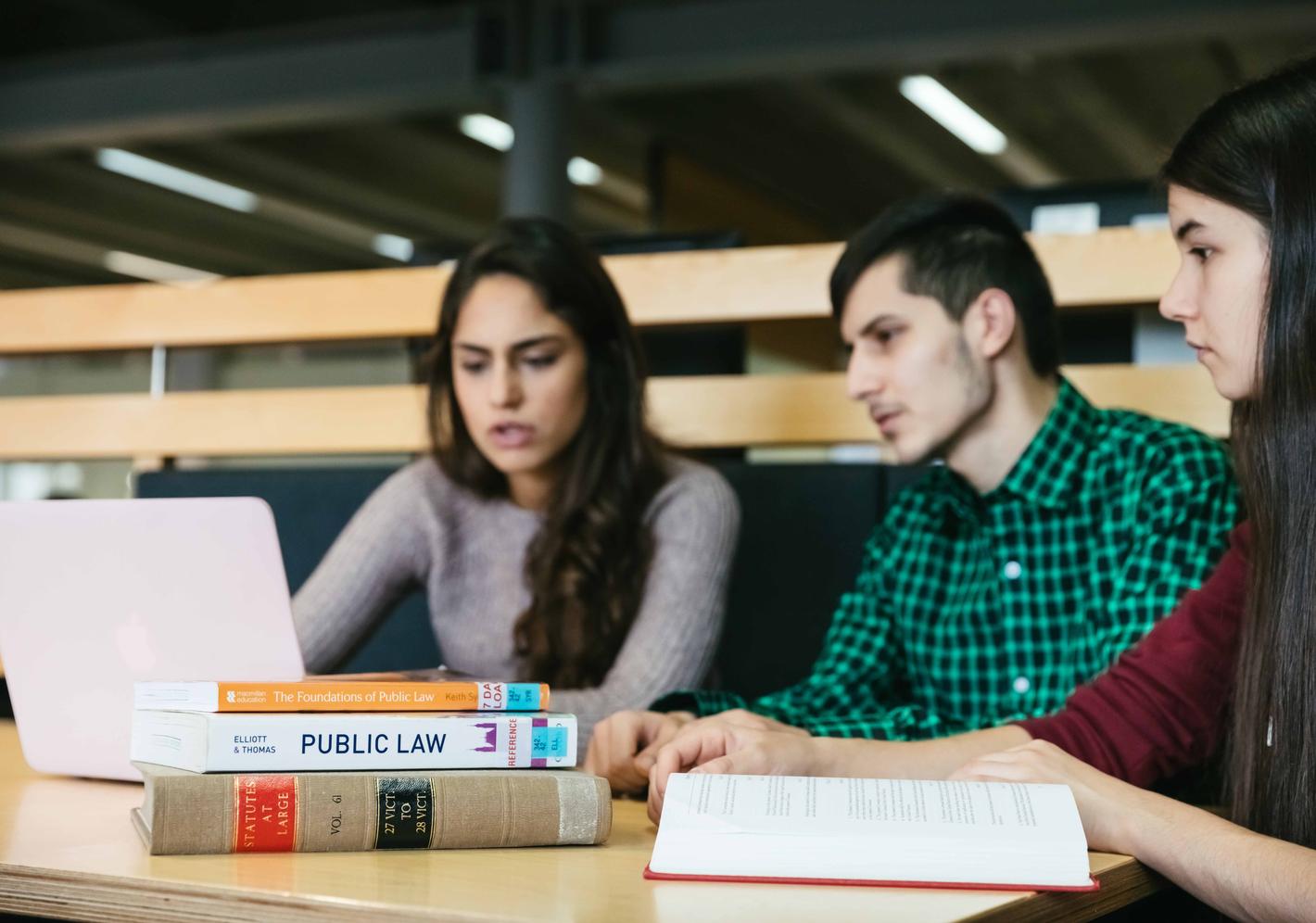 Law students studying together with their laptop and law books