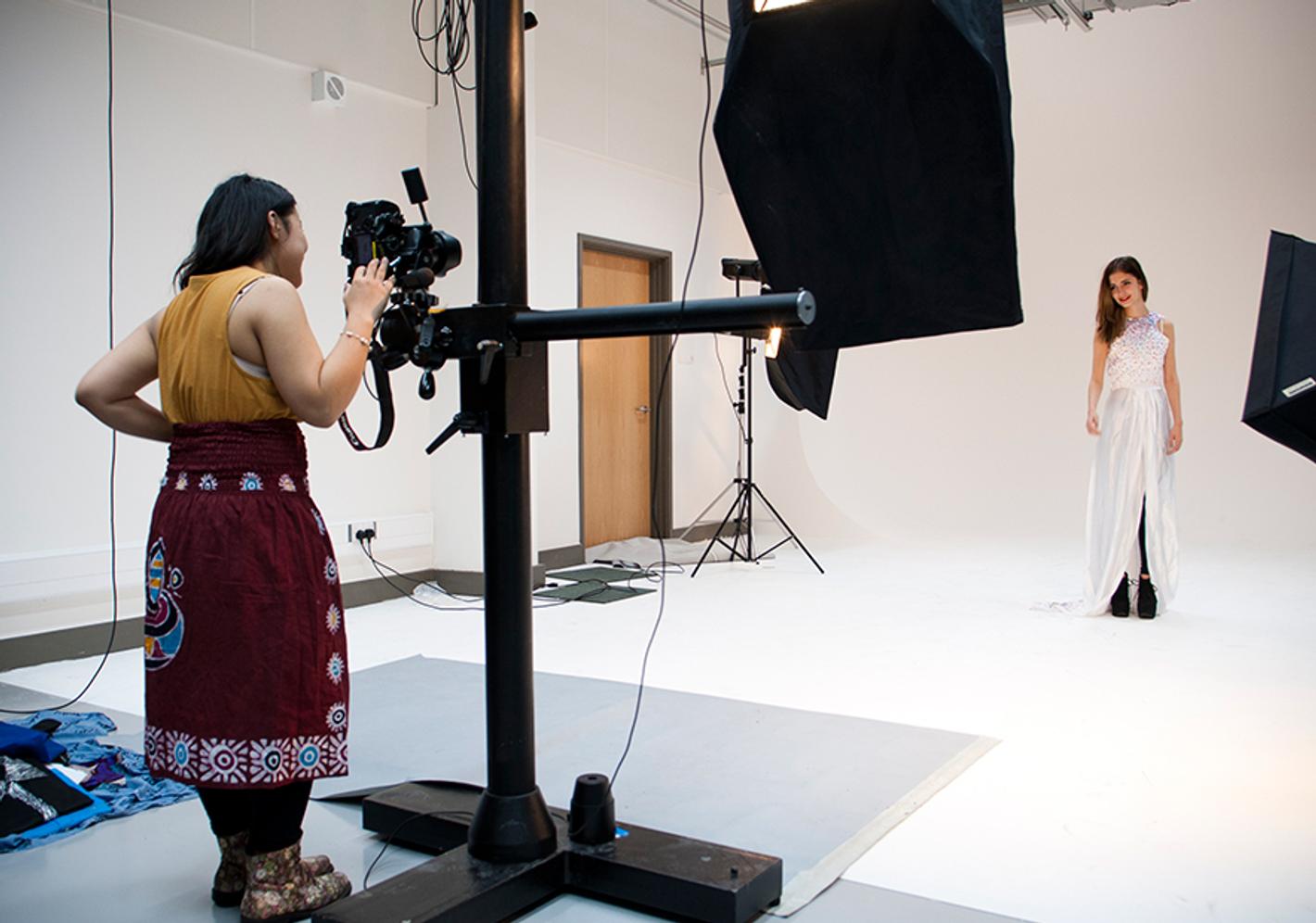 A photographer taking a photo of a model