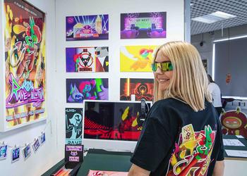 Students poses next to her work at fashion show