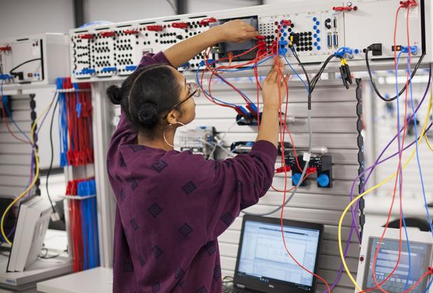 A student plugging in cables