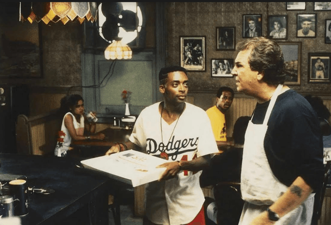 Still from Do the Right Thing, Spike Lee character holding Pizza box