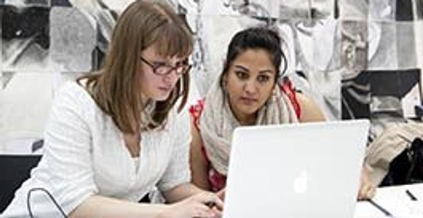 Two Middlesex students working on laptop